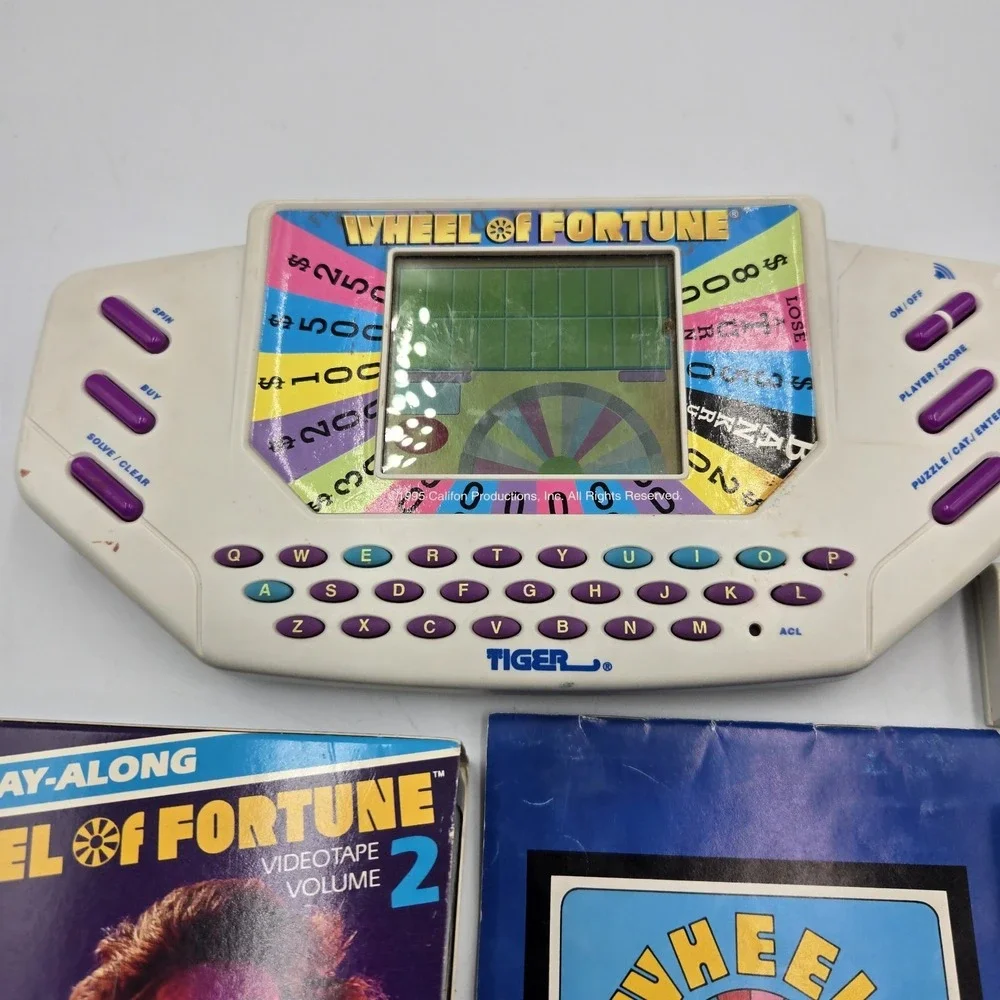 1995 Tiger Hand Held Electronic Wheel Of Fortune Expansion Cartridges Book & VHS